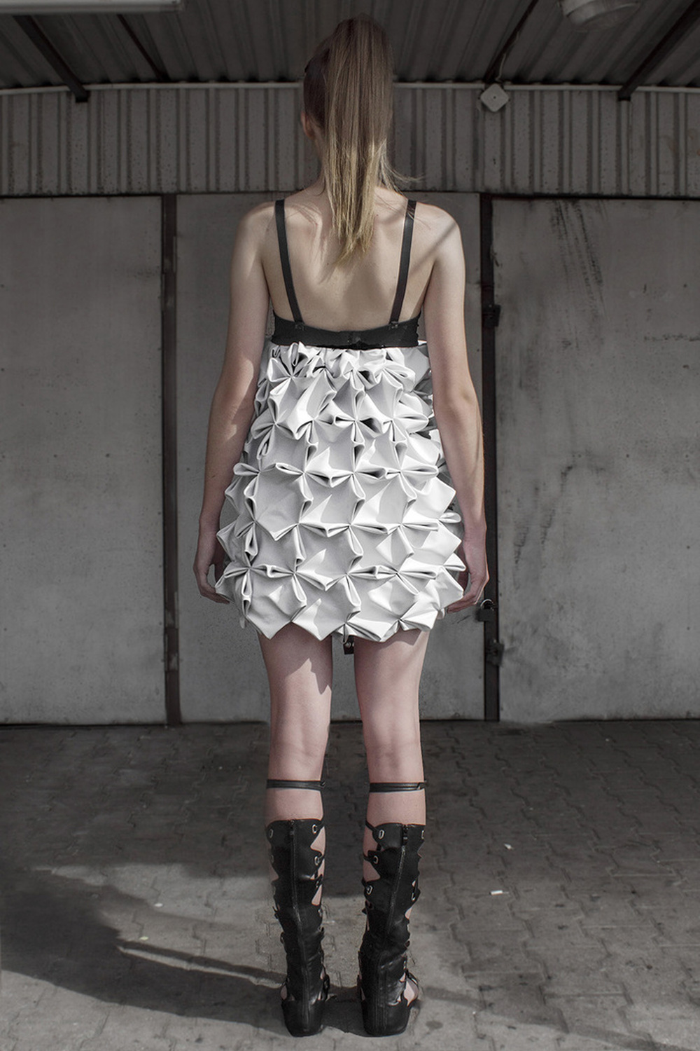 Look 8

Hand-smocked, sculptural, leather dress with raw, metal embellishments 