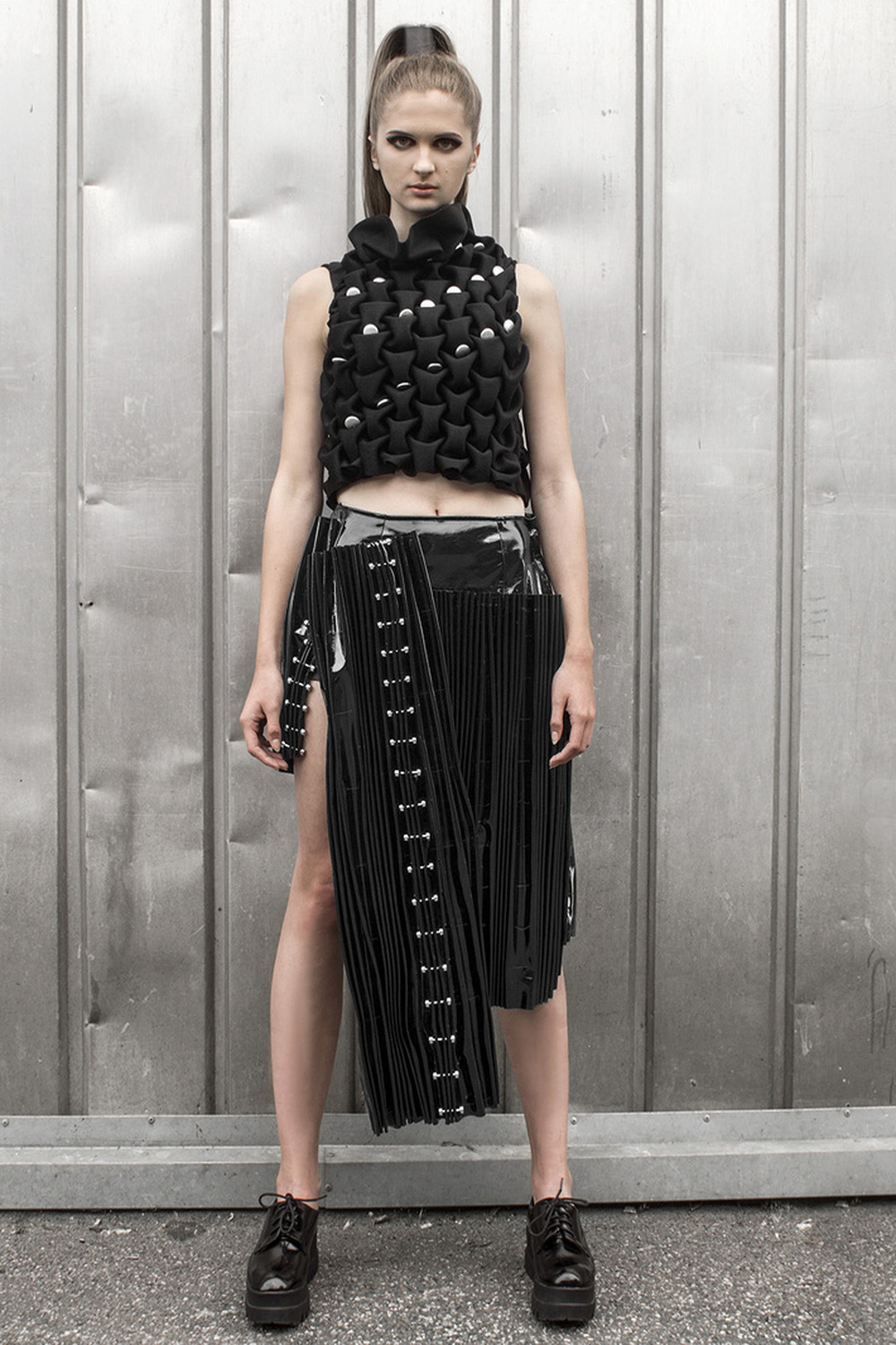Look 6

Hand-smocked cashmere top with metal embellishments and a pleated, black vinyl skirt 